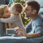 picture of young parents with a baby for the 2022 sleep gift guide for the entire family