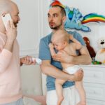 image of a dad holding a thermometer and another dad holding a baby who is sick bella luna family
