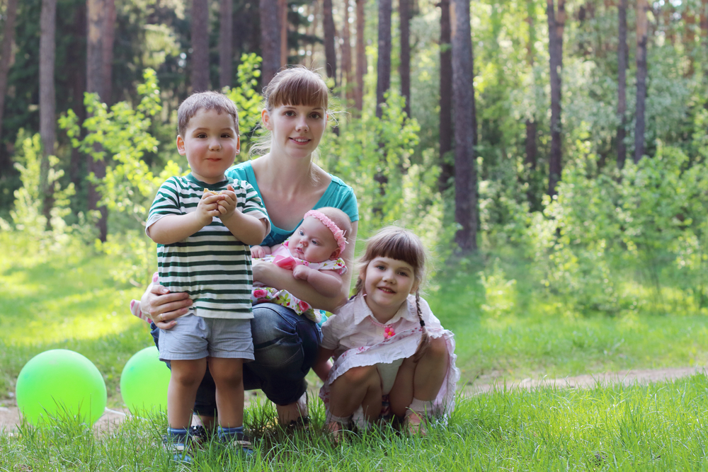 erika testimonial mom with three kids playing in the woods