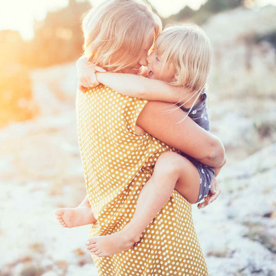 mom hugging toddler daughter