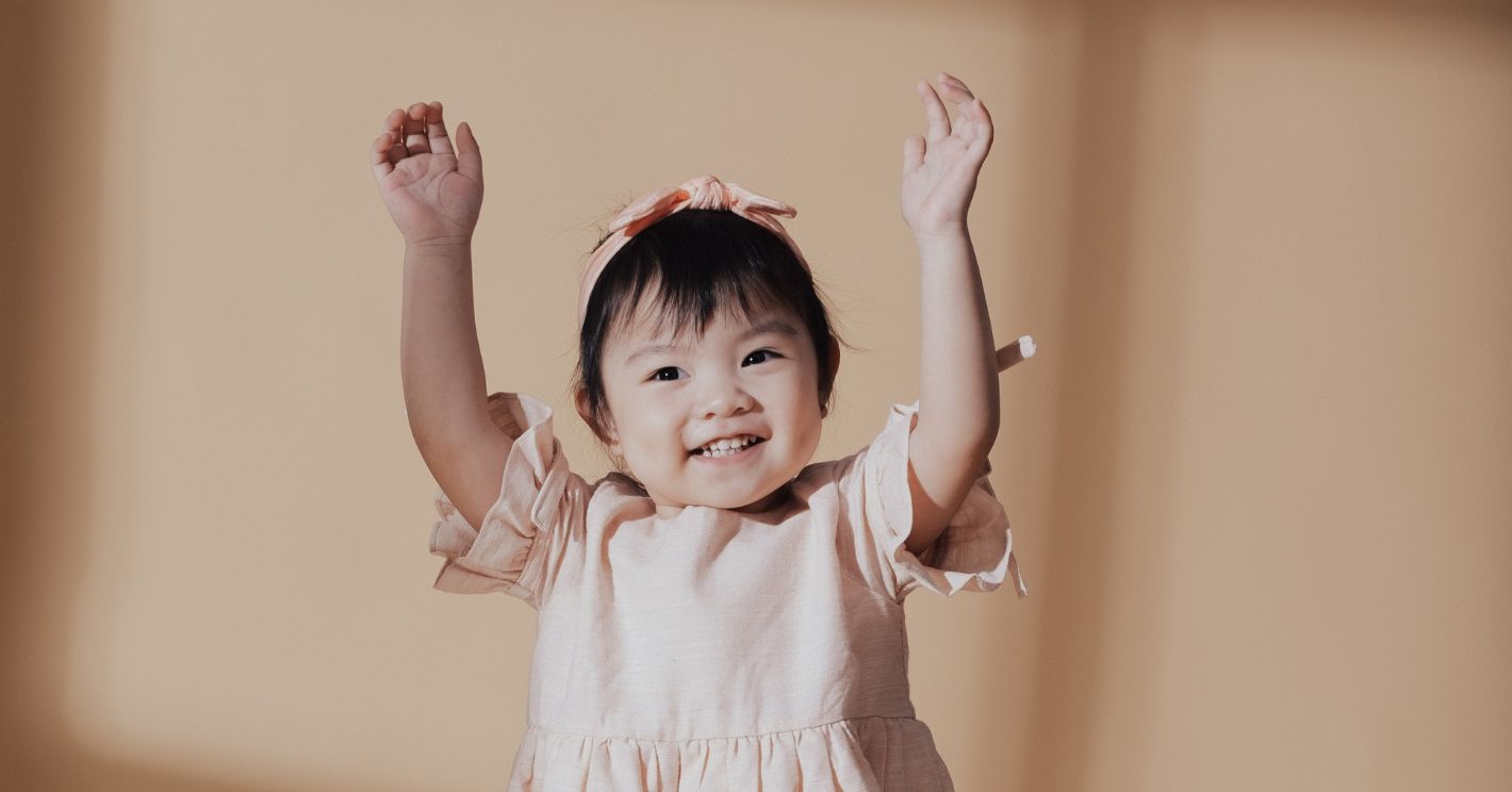 a smiling toddler after a good nights sleep